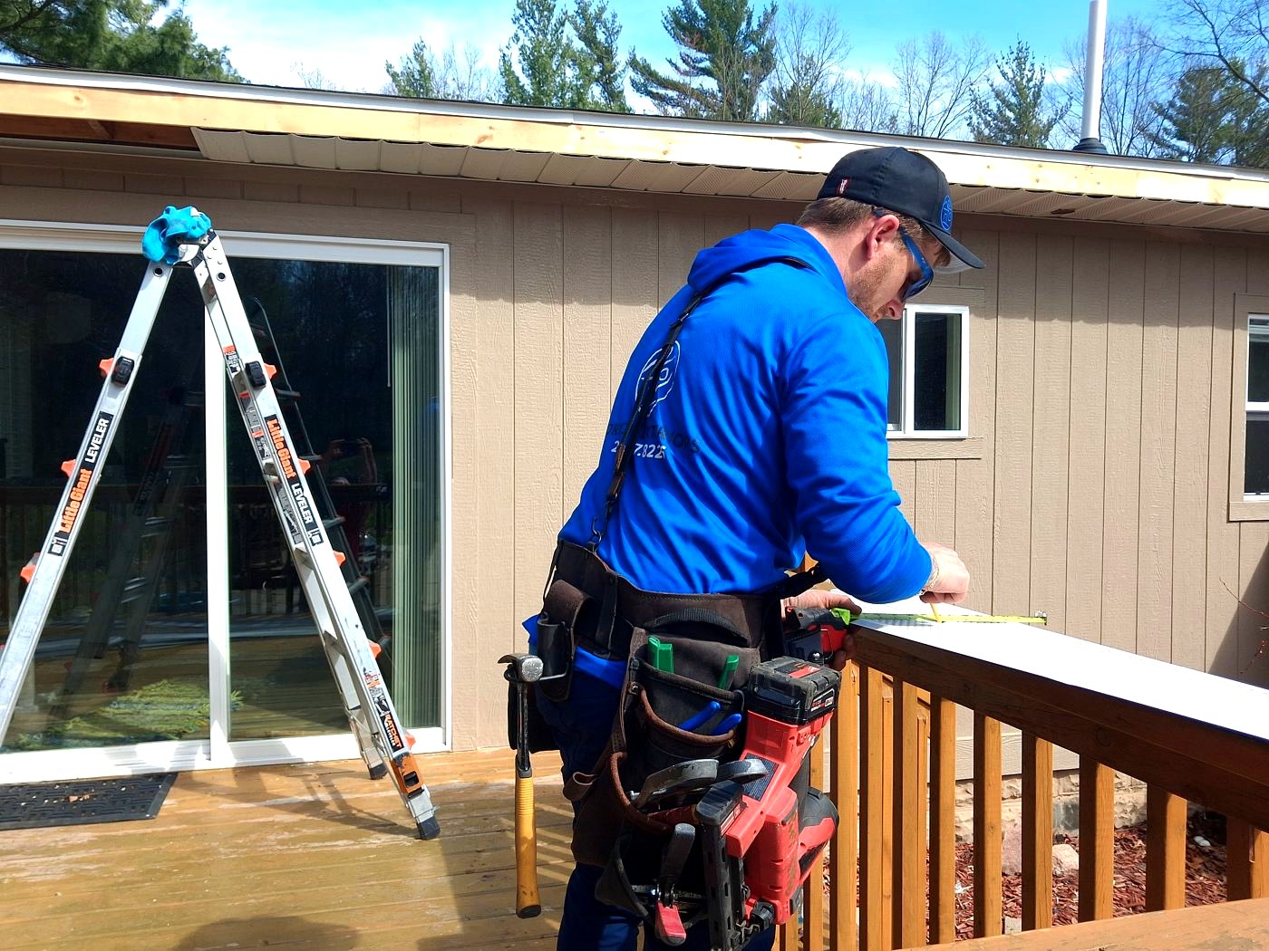 A real local Roof Check crew member measuring on a West Michigan job